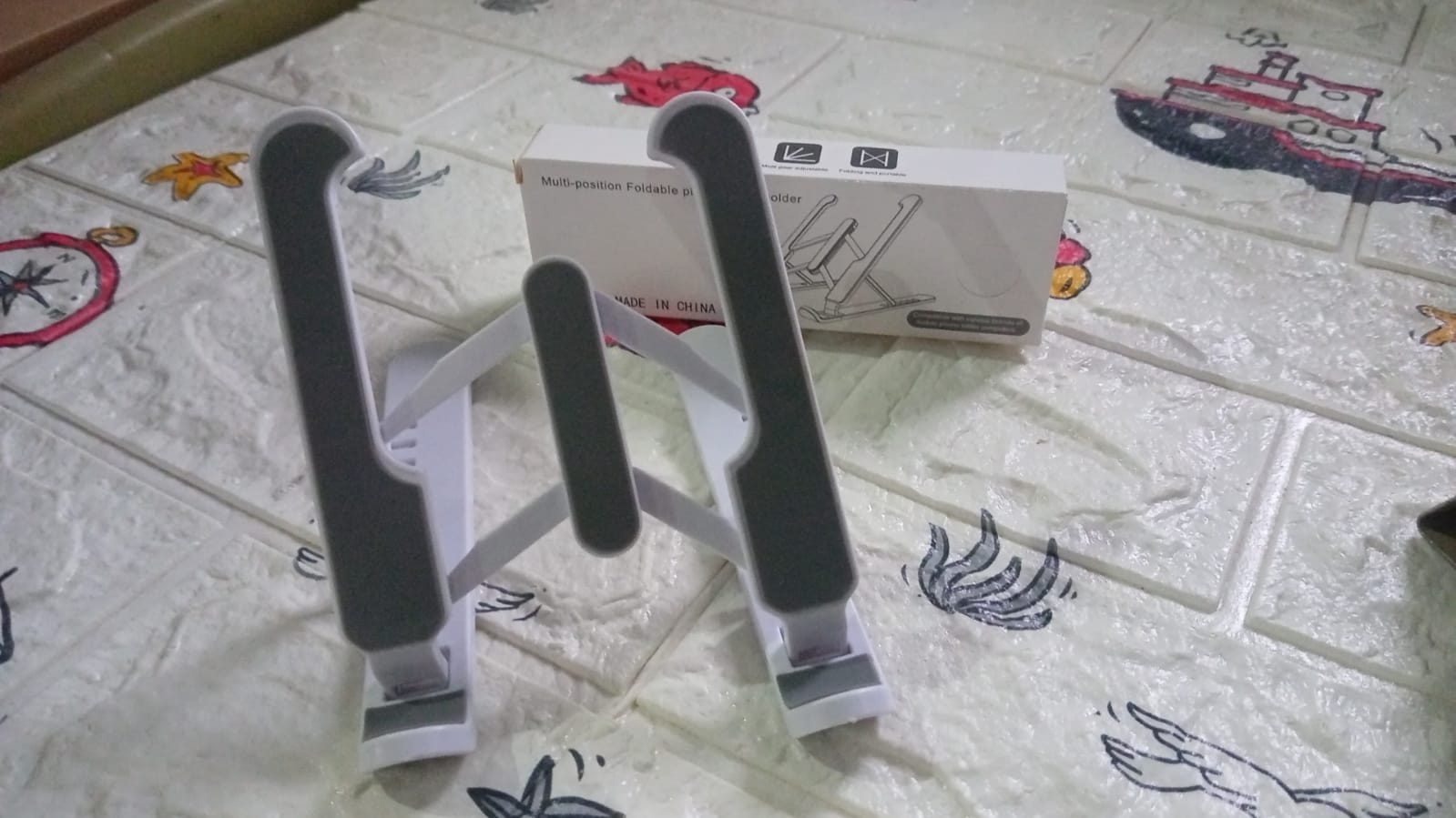Adjustable stand for tablets with foldable legs Adjustable stand for tablets with foldable legs